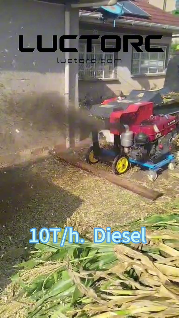The diesel chaff cutter running on site in Kenya, throwing a jet of chopped maize stover onto a heap beside it