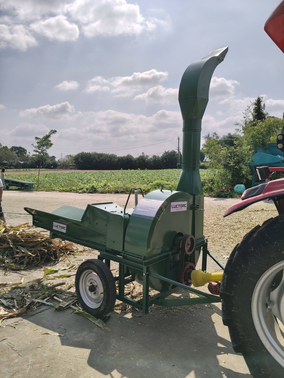 Drive-side view showing the yellow PTO shaft and paper label reading Kenya George Narok on the chaff cutter