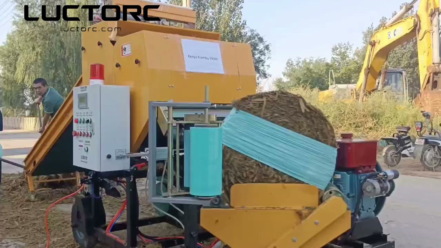 A bale on Victor's tagged LUCTORC baler wrapper further through the film-wrapping pass